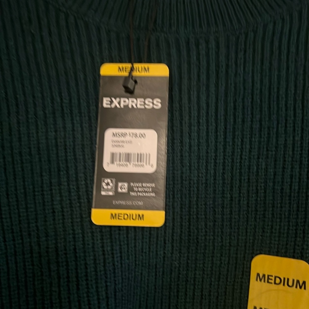 A green express woman’s sweater